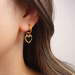 Black heart enamel hoop earring worn on the ear