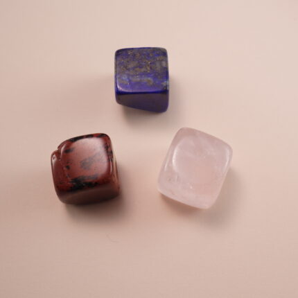 Set of three crystal cubes – rose quartz, lapis lazuli, and red jasper – representing love and harmony.