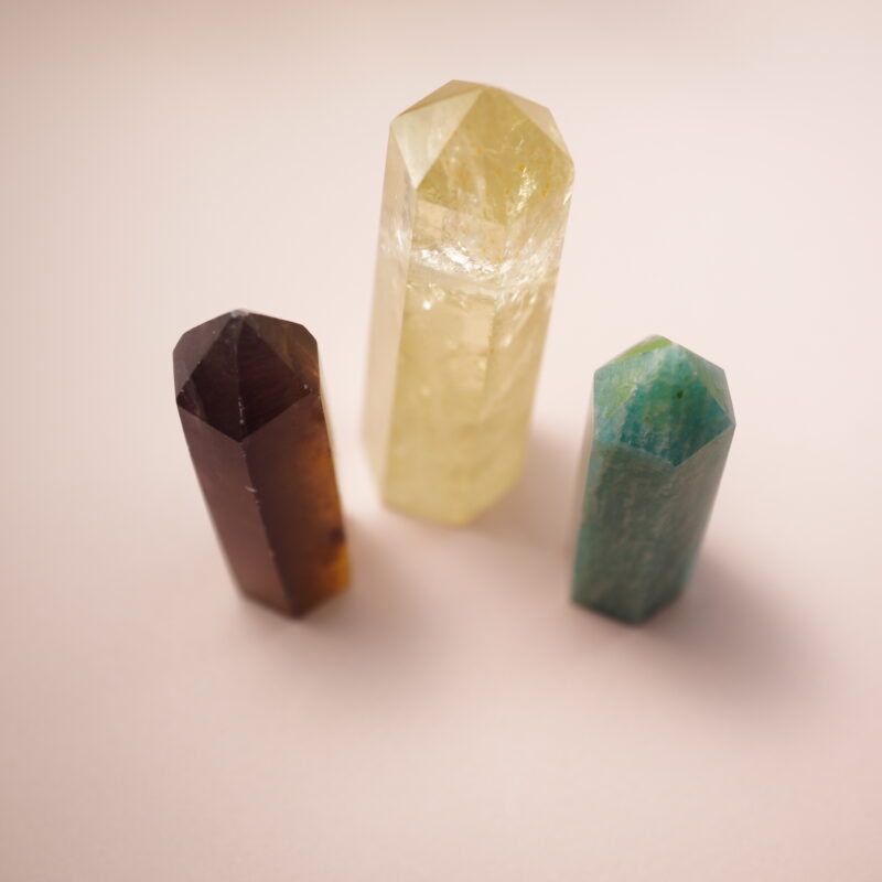 Set of three crystal points – smoky quartz, citrine, and amazonite – symbolizing wealth, positivity, and balance.