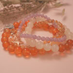 Warm-toned vitality bracelet stack displayed in gentle sunlight, symbolizing life energy and renewal.