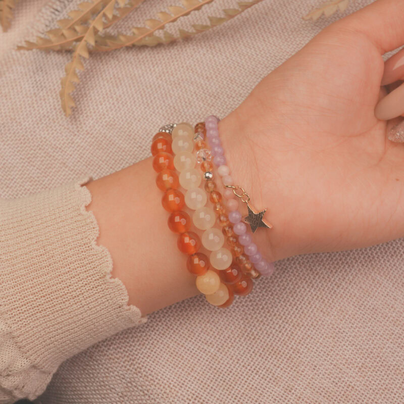 Model wearing the Sunrise Glow vitality bracelet stack, expressing optimism and radiant charm.