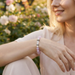 A woman wearing a crystal bracelet with her arm resting naturally outdoors, conveying a relaxed and elegant lifestyle.