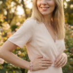 A smiling woman wearing a crystal bracelet outdoors in natural light, expressing a relaxed and confident lifestyle.