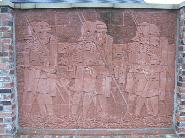 Relief of soldiers in uniform carved on brick wall for UK Narrowboat Life blog.