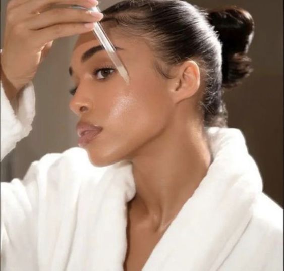 Touching the skincare pipette to your face