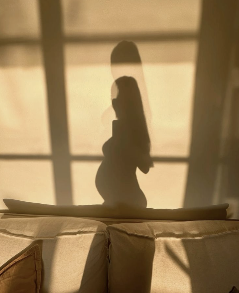 A shadow of a pregnant woman.