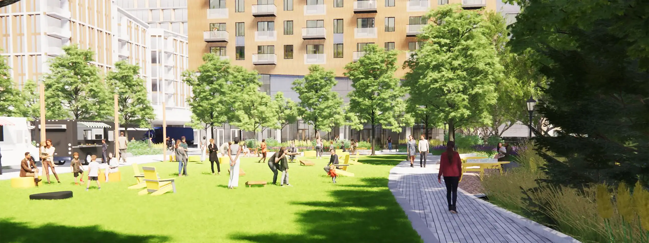People enjoying a sunny day in a green urban park with trees and walking paths.