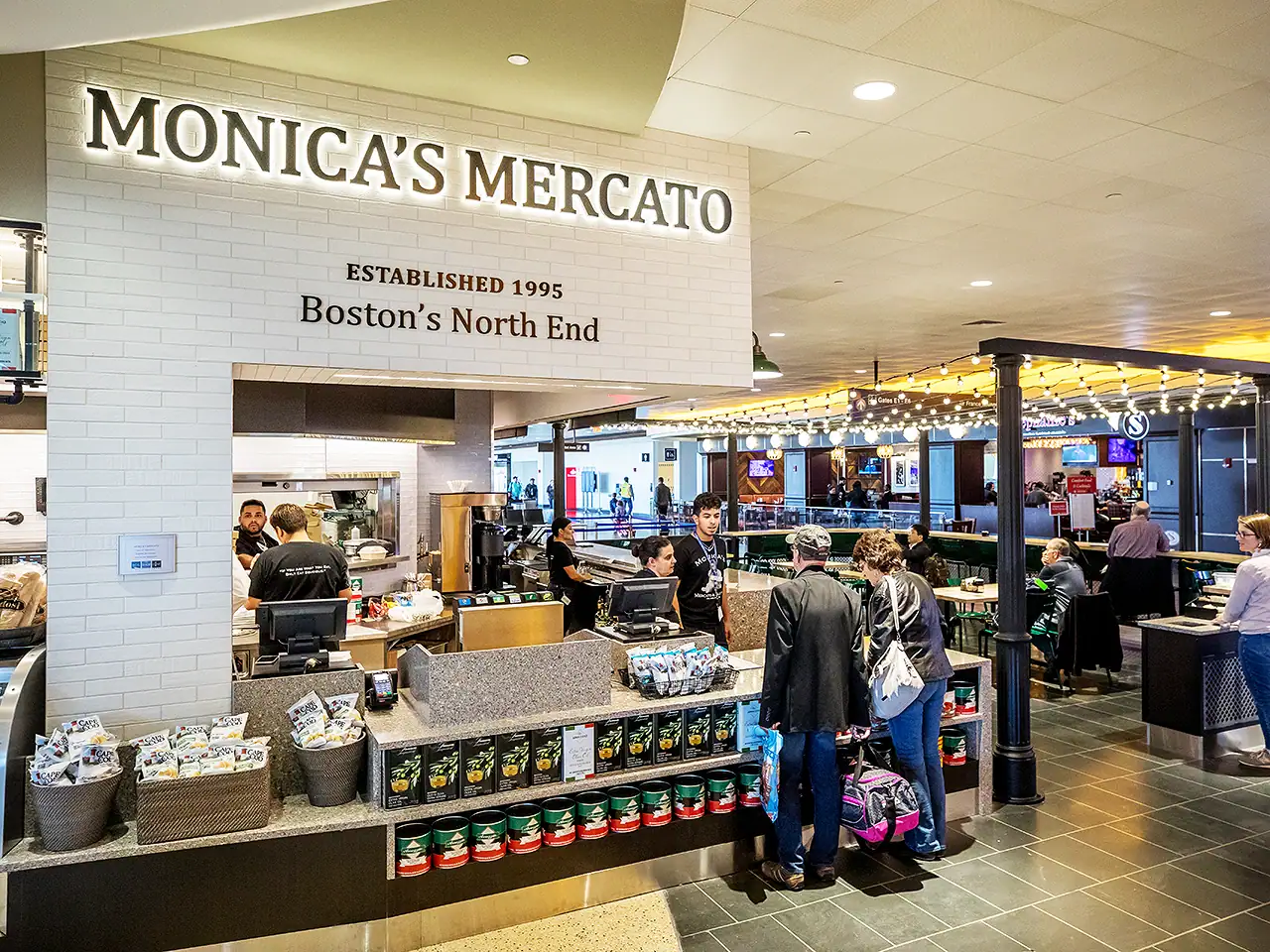 Inside Monica's Mercato at Boston's North End with customers and staff.