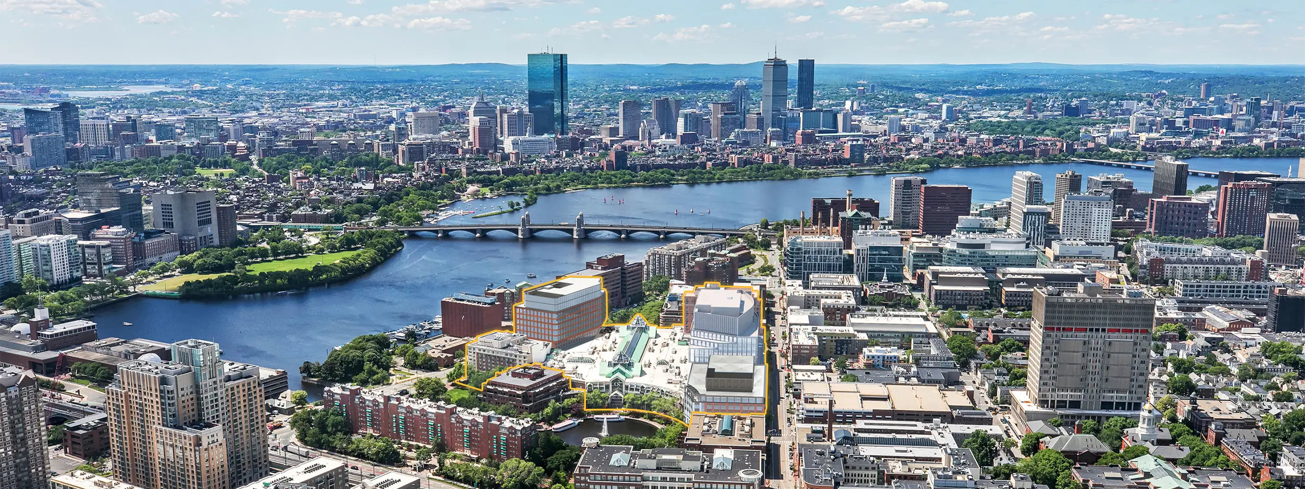Aerial view of Boston skyline with Charles River and downtown buildings.