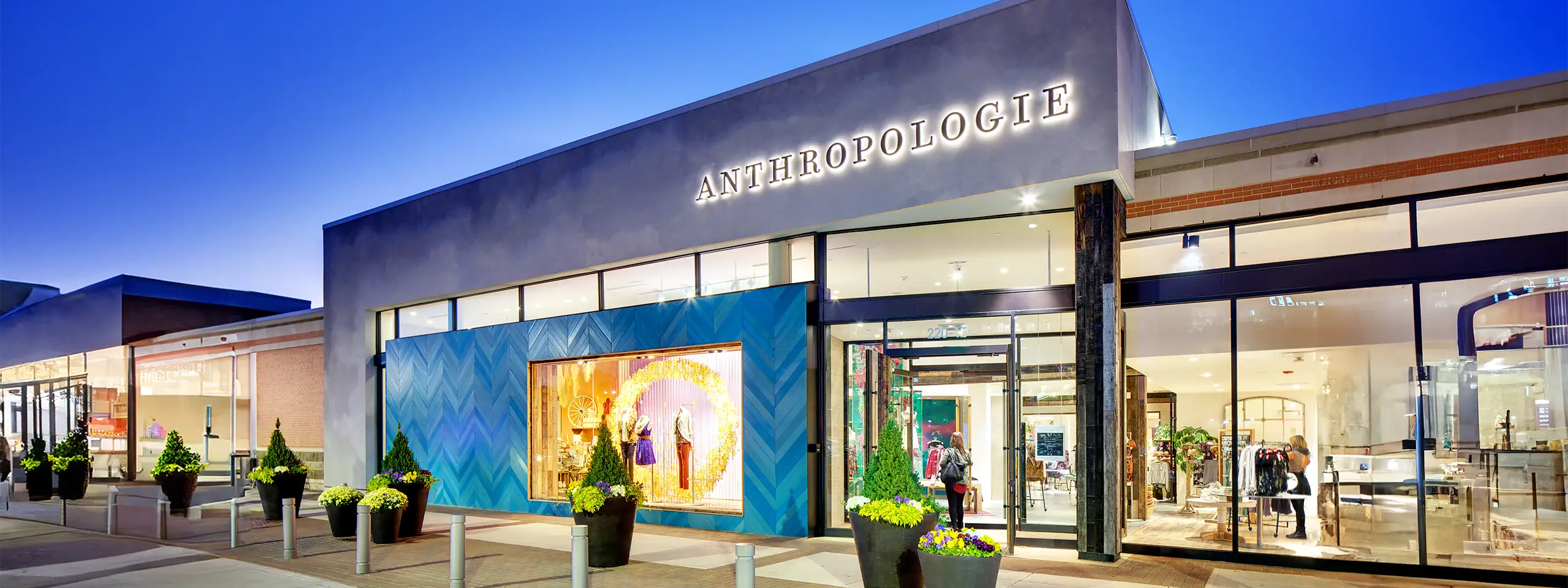 Anthropologie store exterior with large display window and modern design.
