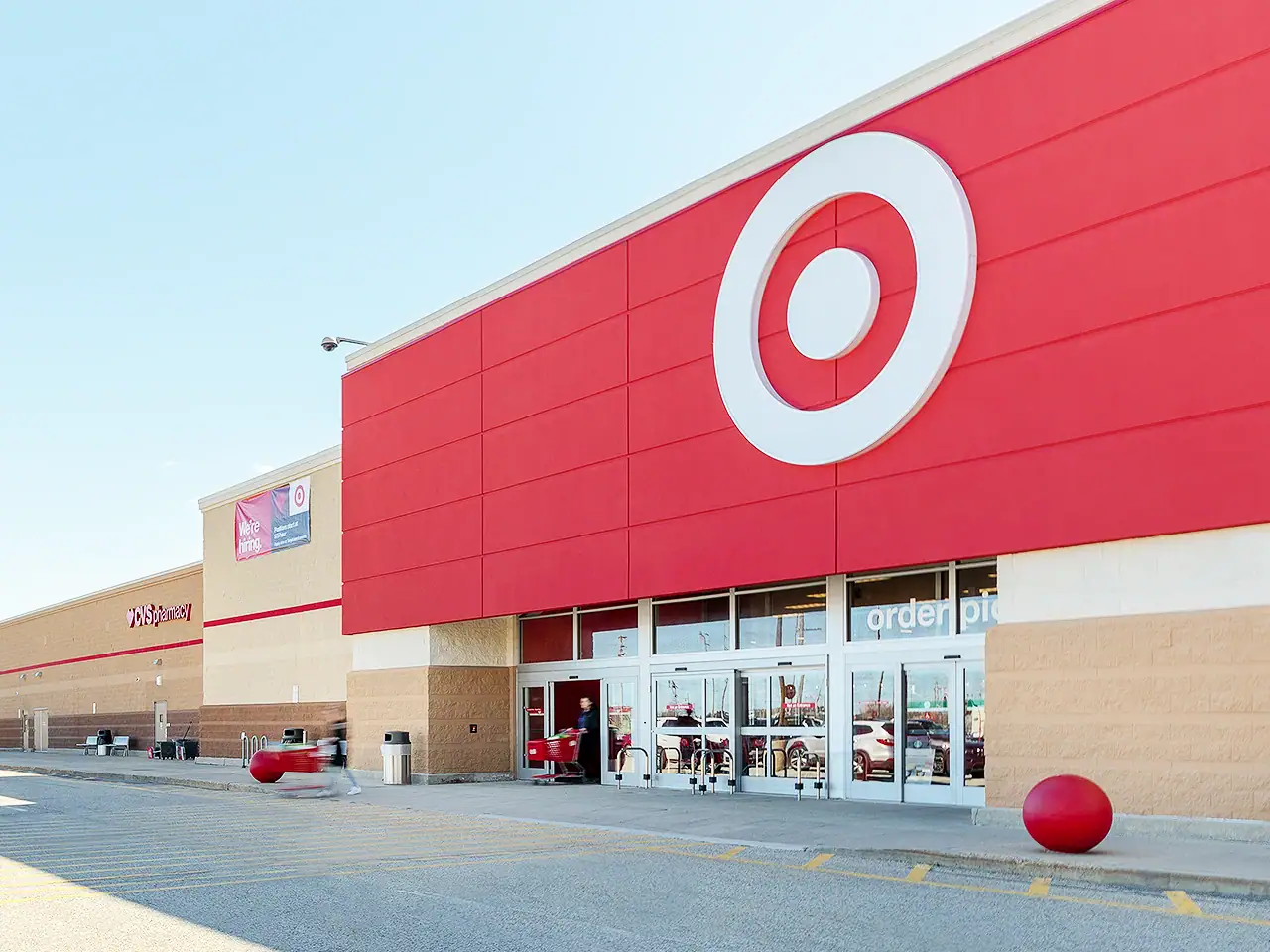 Target store entrance with red logo and shopping carts outside.