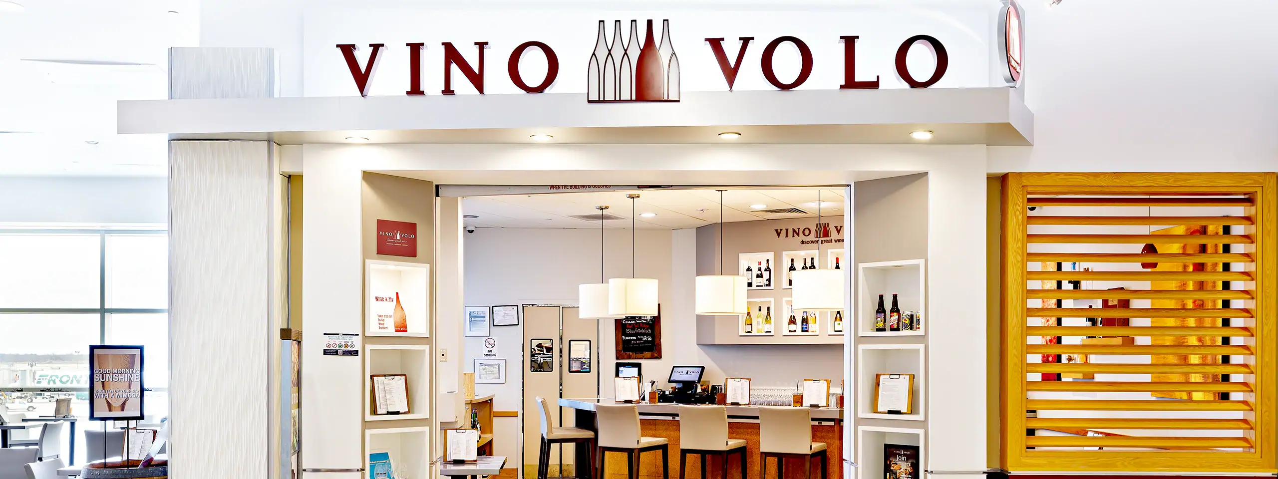 Vino Volo wine shop interior with shelves and a checkout counter.