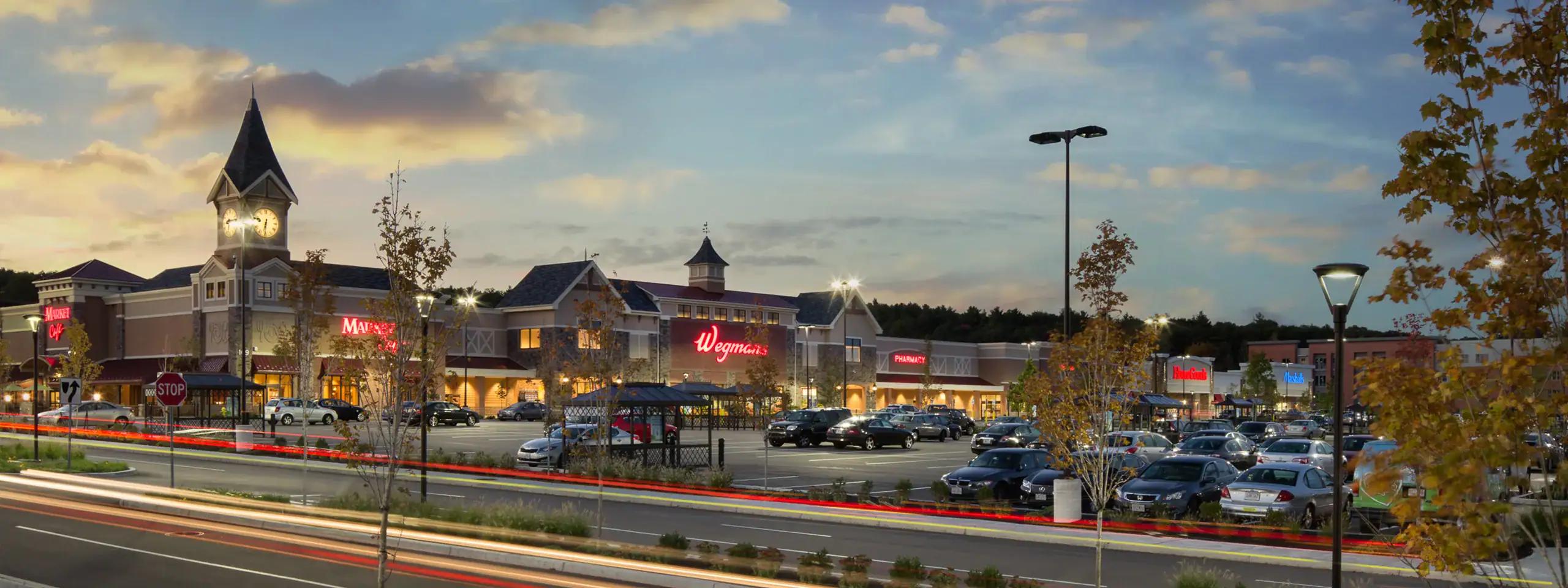University Station in Westwood, MA. Wegmans, HomeGoods and Marshalls storefronts showing.