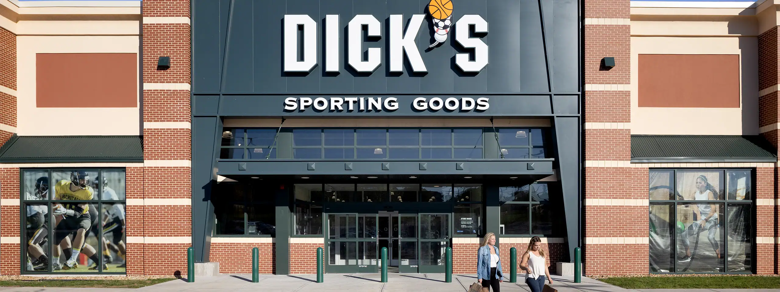 DICK'S Sporting Goods store entrance with large sign and glass doors in a shopping mall.