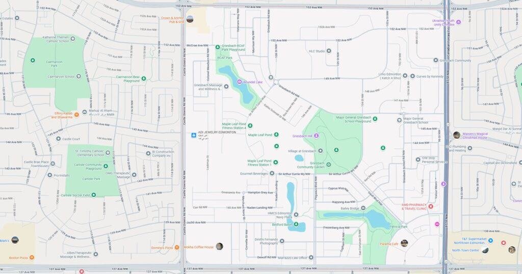 Bright park featuring a playground, a pond, and walking trails in a residential neighborhood.