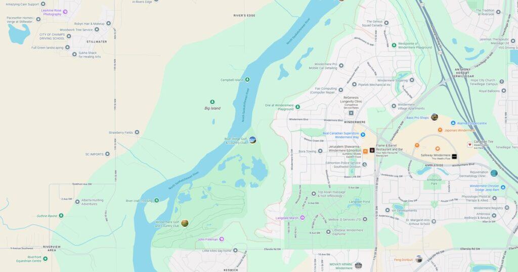 Scenic view of North Saskatchewan River with lush greenery and island features, perfect for outdoor recreation and nature walks in Windermere.