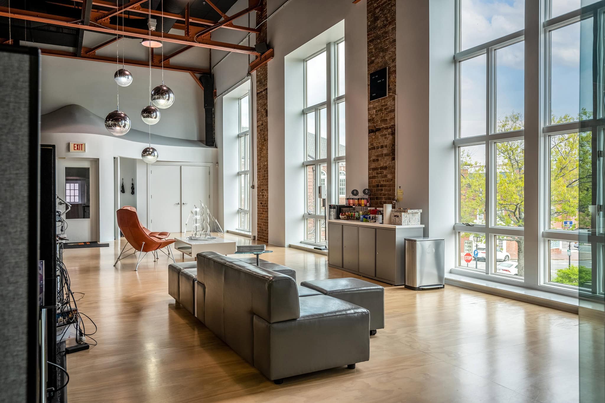 Modern lobby with large windows, leather seating, and contemporary decor.