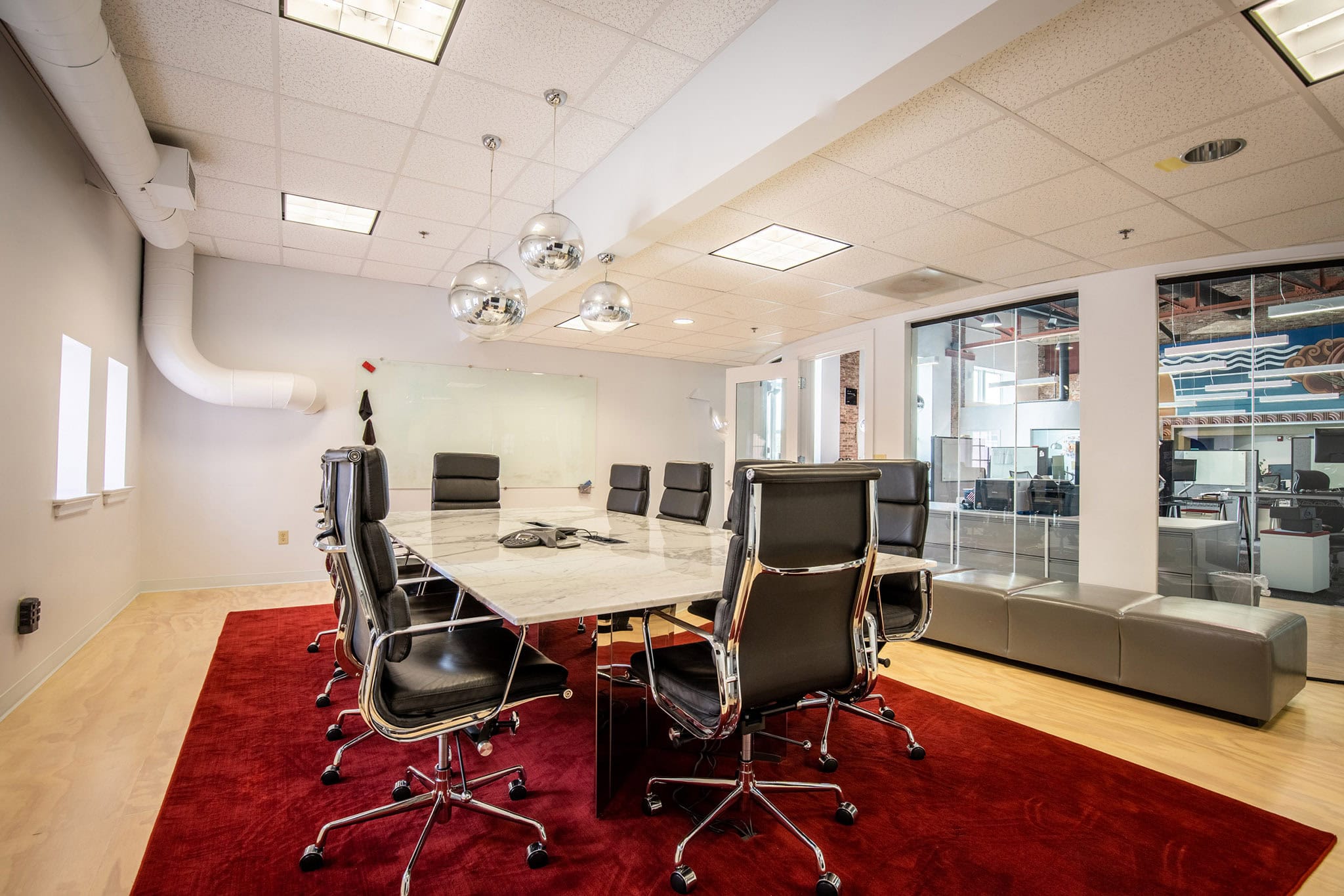 Modern conference room with large table, black chairs, and glass walls in Newburyport.