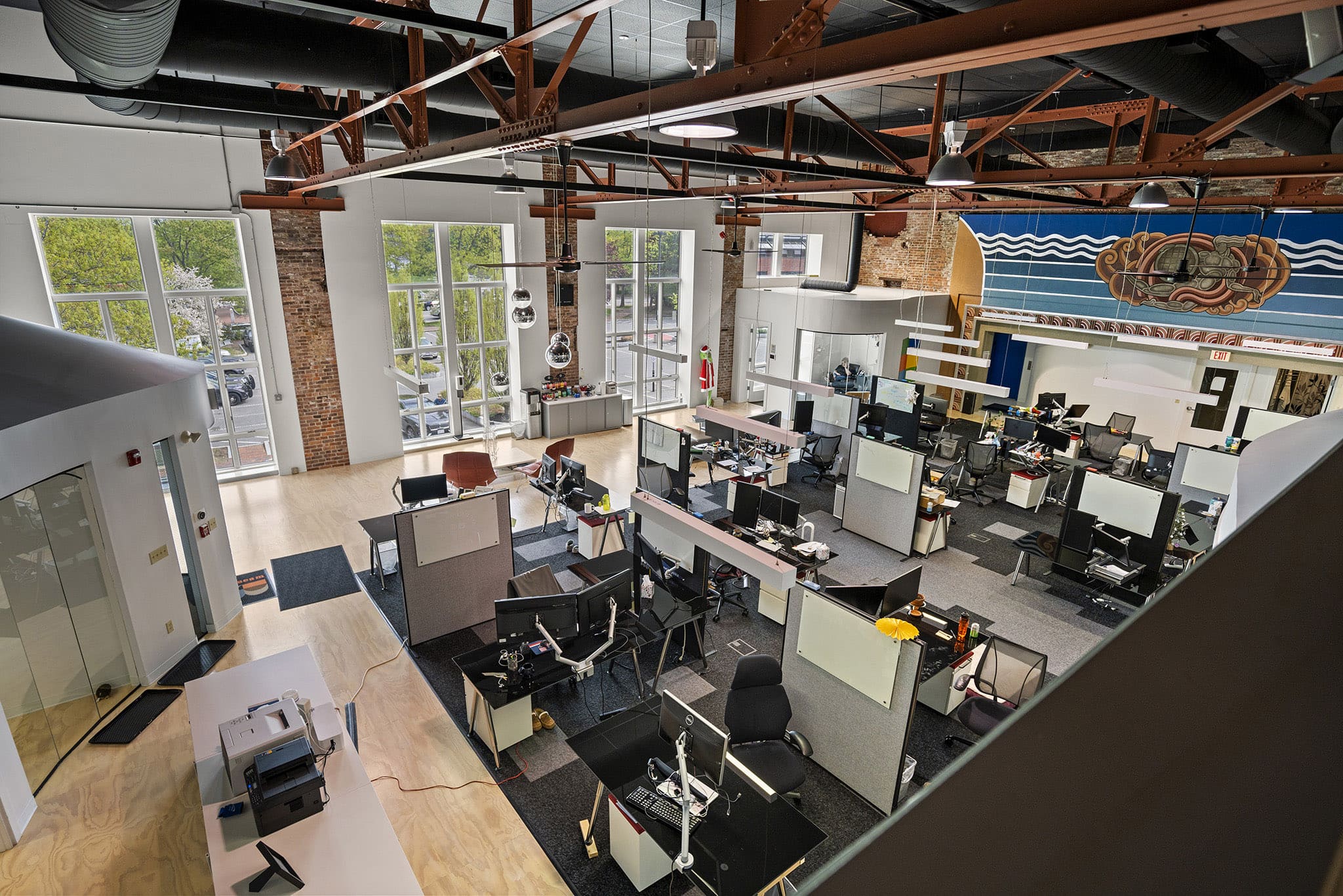 Modern open-plan office with desks, chairs, and large windows in Newburyport.