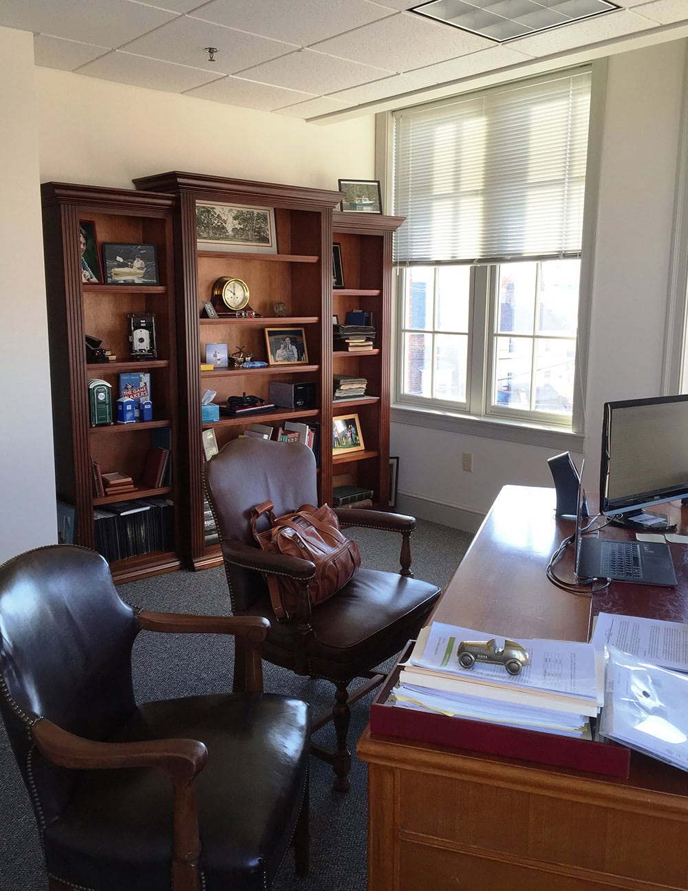 Office with wooden furniture and leather chairs