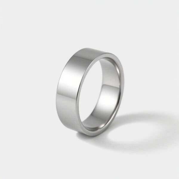 A close up image of a silver tungsten flat ring. The perfect choice as a mens wedding band. Set on a white background.