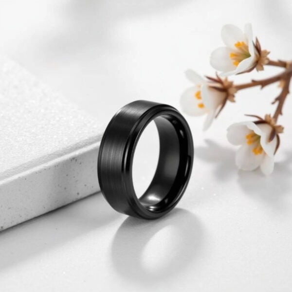 Mens engagement ring or wedding band for him. An all black tungsten ring, with a raised centre that has a brushed finish, and polished edges