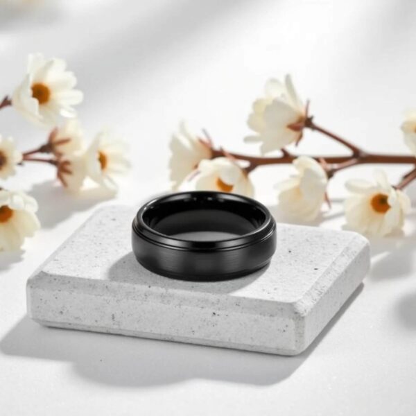 A black tungsten ring for him - polished bevelled edges and a slightly raised centre section that has a brushed finish. Perfect as a wedding ring for him, or as an anniversary gift for him.