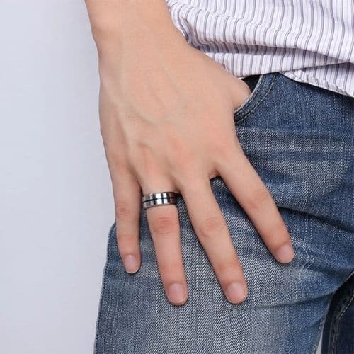 Man tries on his silver tungsten ring with blue groove