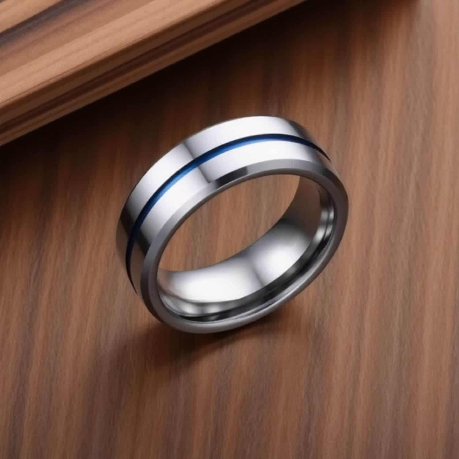 Gents eternity ring made with tungsten. A silver mans ring featuring a distinctive line of blue running through the centre of the ring. With bevelled edges, this is an elegant mans eternity or promise ring.