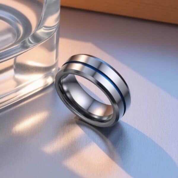 A polished silver tungsten ring featuring a vivid groove of blue. With bevelled edges, this mens ring is perfect as a male wedding band or engagement ring.