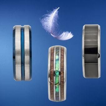 3 titanium men's rings with feather floating above
