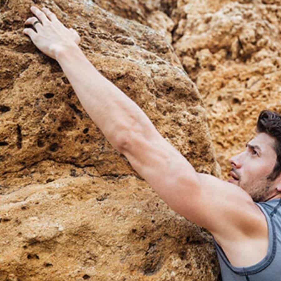 Man rock climbing showing his inspiring ring design