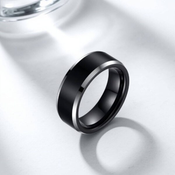 A black titanium ring for men featuring polished silver edges. Perfect as a wedding ring for him, or as a male engagement ring.