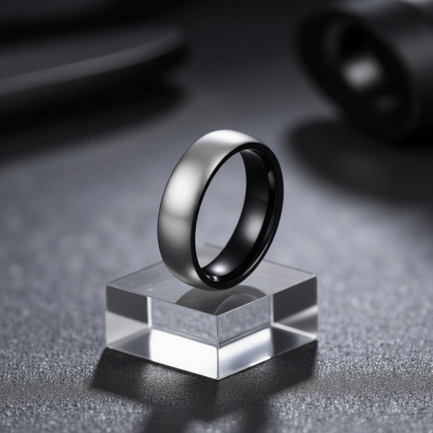 Mans brushed silver titanium ring with a polished black centre and rims