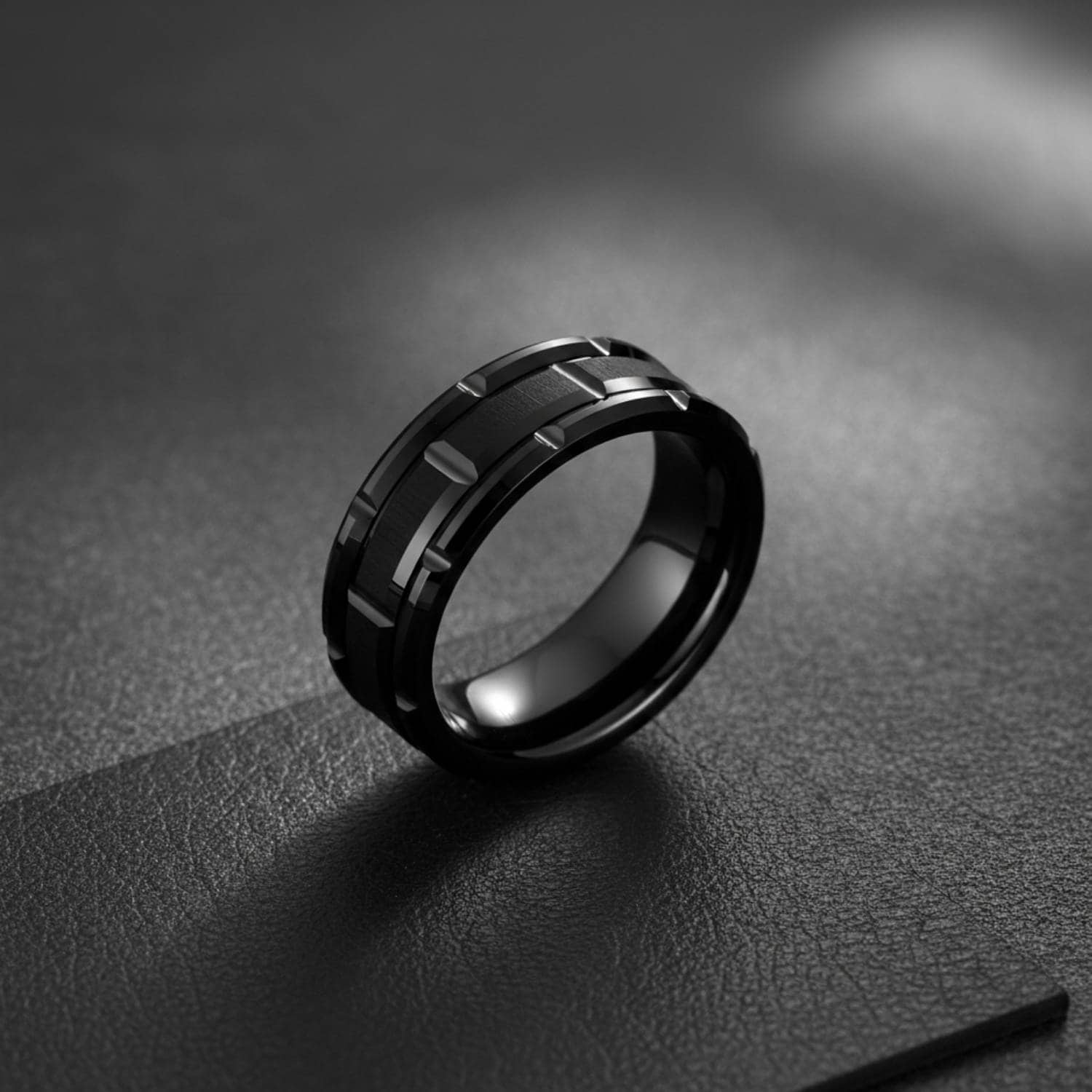 The Tyrone male promise ring in black tungsten, durable mens band with distinctive tread design and modern styling.