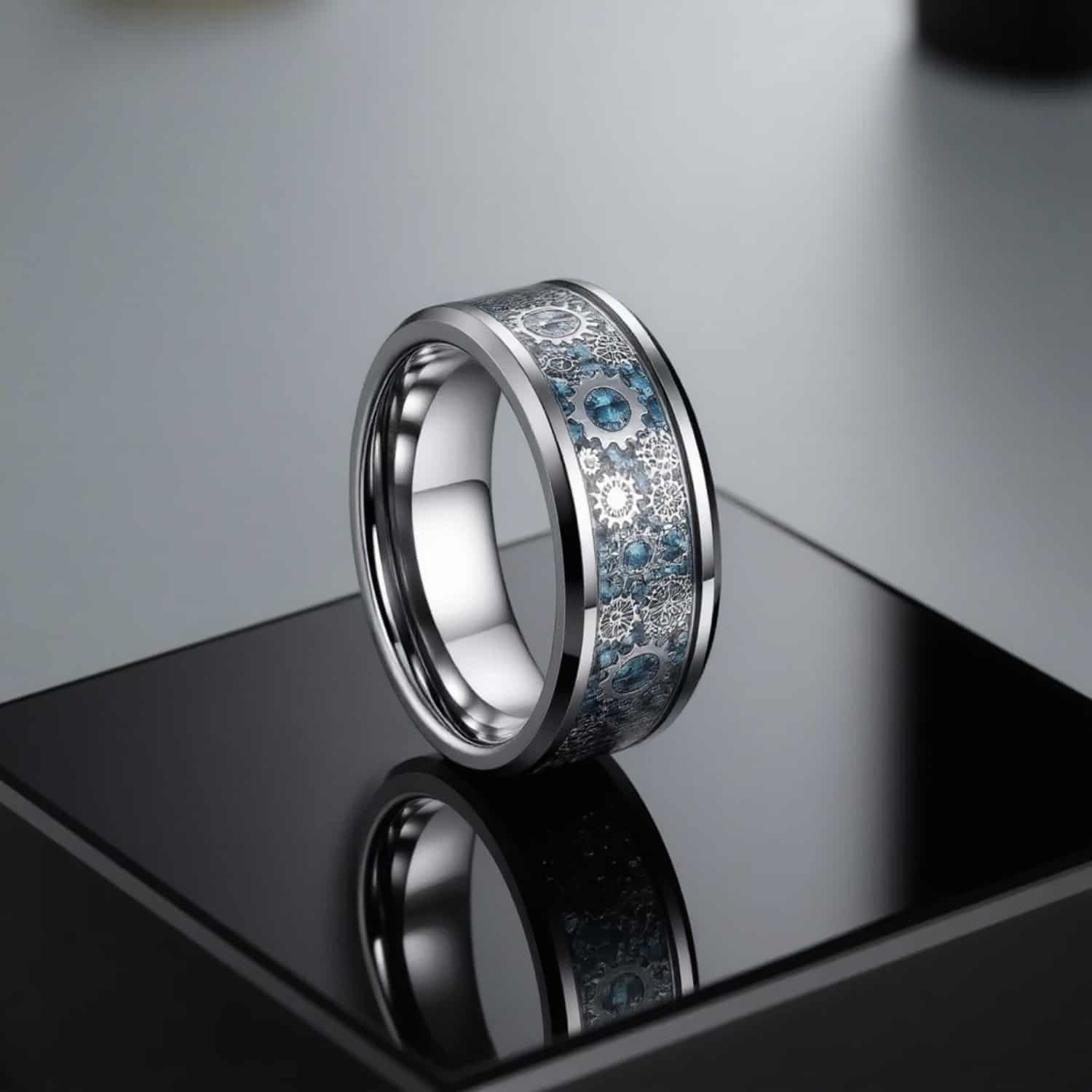 Cogwheel ring for men featuring blue carbon fibre with gear detailing set in a silver tungsten band.