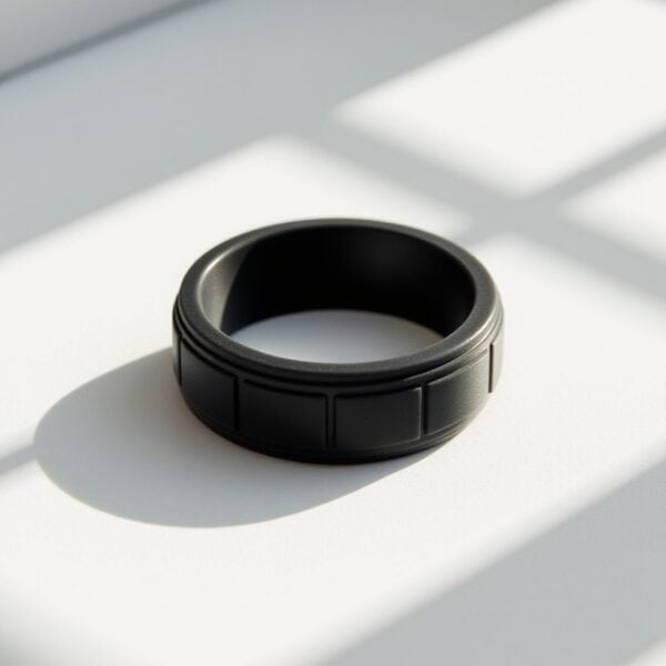 Lightweight black flexible silicone ring for men with block pattern. A versatile male engagement ring, gents eternity ring, or mans stretchy sports band.