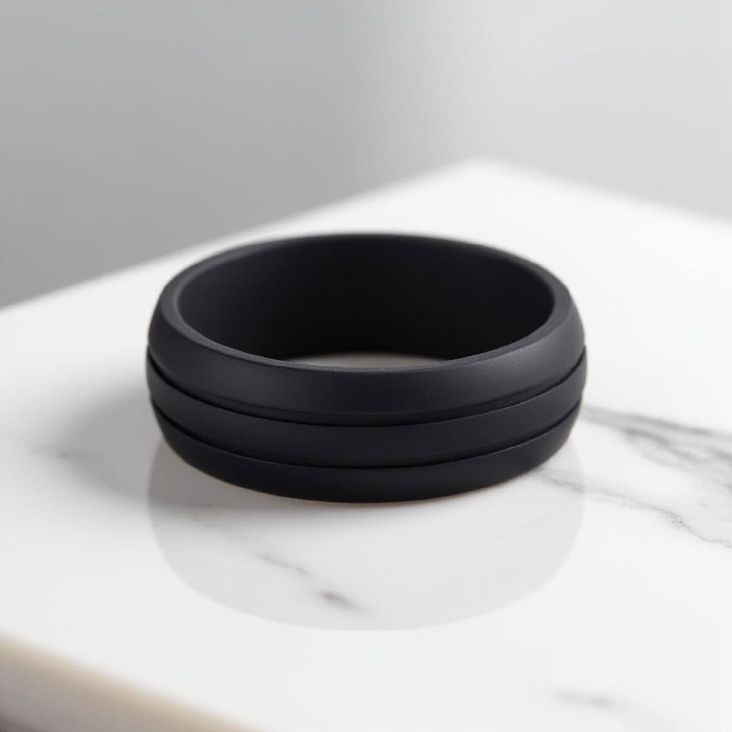 Stylish black silicone ring for men with double grooves. A mans wedding band, gents promise ring, or flexible stretchy ring for guys.
