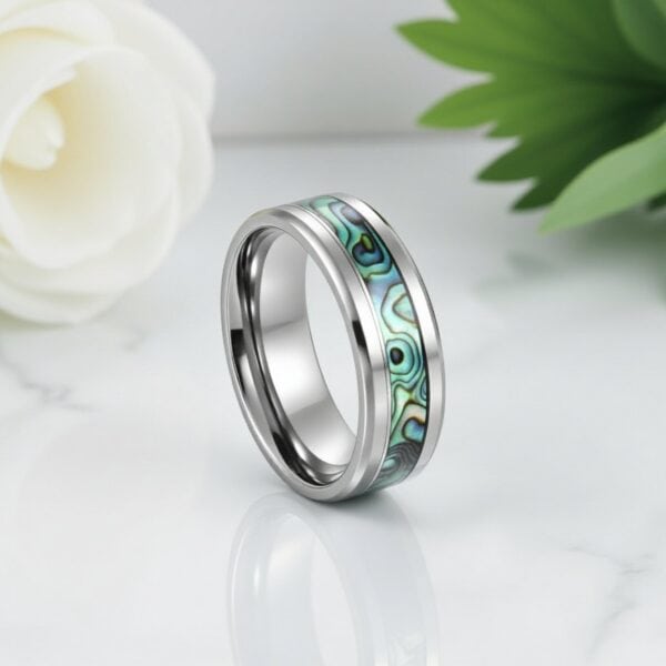 Titanium men’s wedding ring with abalone shell inlay — lightweight, durable, and engravable for him.