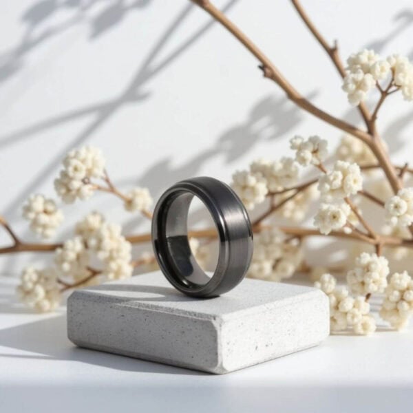 A striking and strong gunmetal grey ring for him. With polished edges, and a raised brushed centre. Made with tungsten.