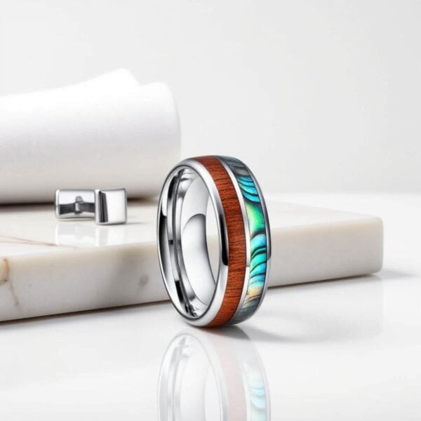 A silver tungsten ring for men with inlays of wood and abalone shell