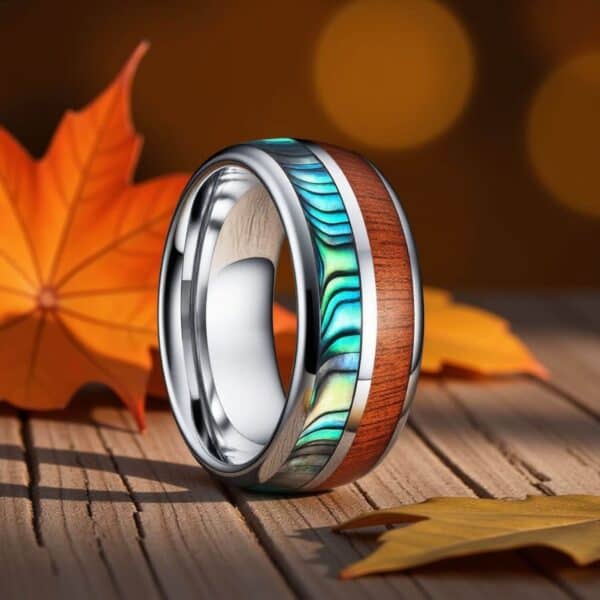 A silver tungsten ring with contrasting inlays of wood and shimmering shell. A wedding band for men