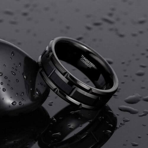 The Tyrone men’s black tungsten ring with tyre-inspired brick pattern, brushed and polished finish, bold mens wedding band for him.
