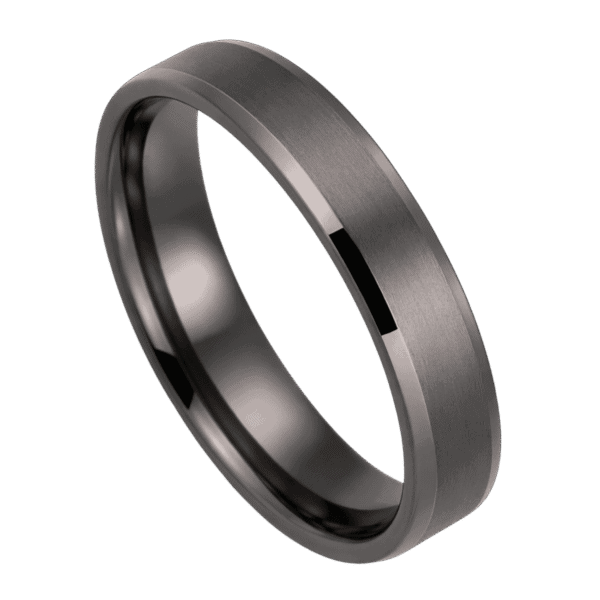 A zoomed in shot of a gunmetal grey tungsten ring. It has a brushed finish and bevelled edges.