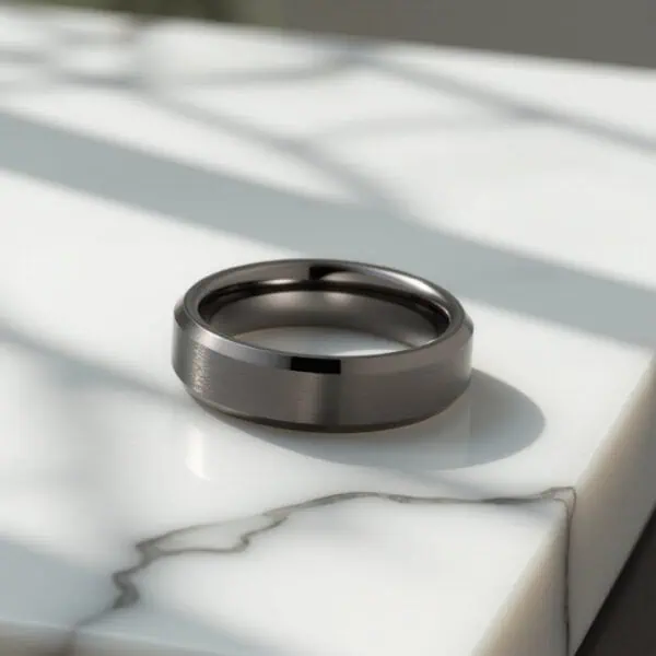 The Driven gunmetal grey tungsten men’s ring featuring a brushed centre and polished bevelled edges — perfect as a wedding or statement ring.