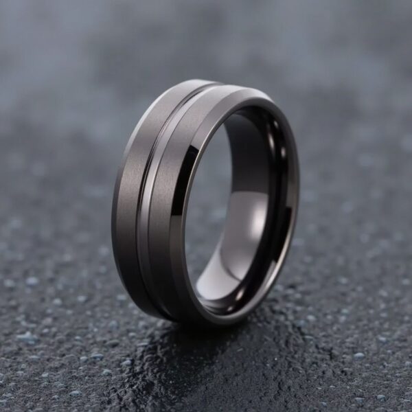 The Stealth combines sleek gunmetal grey tungsten with a distinctive grooved centre and a mix of brushed and polished textures. Designed for men who value durability and bold design, this band stands out in every setting. Whether chosen as a men’s wedding ring, engagement ring, or fashion ring, it delivers modern masculine appeal. Personalise it with a name, date, or special message inside.