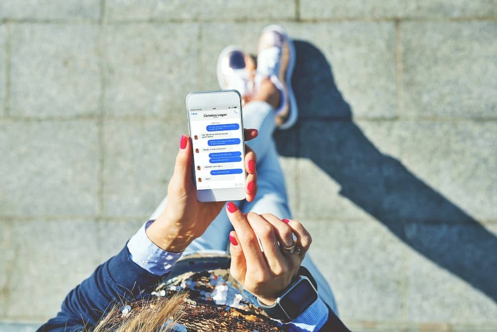 Woman using instant messaging app on mobile phone Woman using instant messaging app on mobile phone