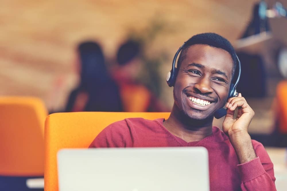 Customer Service agent in an startup office with laptop Customer Service agent in an startup office with laptop