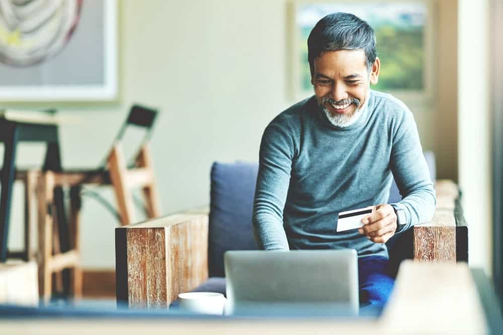 man using Laptop and credit card payment shopping online with customer network connection via omni channel system