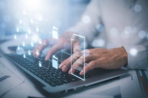 Businessman working on laptop with virtual screen. Online documentation database, IT consultant being set up Virtual Document Management System with laptop,Software for archiving corporate files.